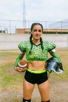 Portrait of mexican woman american football player wearing uniform with velociraptor skin patterns photo