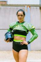 Portrait of mexican woman american football player wearing uniform with velociraptor skin patterns photo