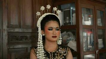 a Javanese bride wears jasmine on her head and makeup on her face video