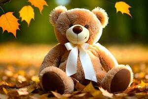 Teddy bear with autumn leaves. cute teddy bear and yellow leaves background. Autumn concept photo