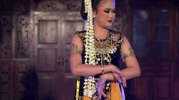 a group of Javanese dancers dances together in a pavilion very gracefully video