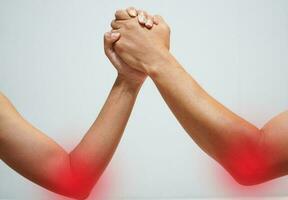 Two man's hands clasped arm wrestling Unequal match photo