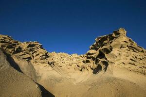 Vlychada beach volcanic ash sand rock formation on Santorini island in Greece photo