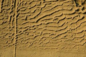 Closeup of Vlychada beach volcanic ash sand rock formation on Santorini island in Greece photo