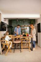 Young family preparing vegetables in the kitchen photo