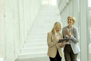 Business women walking in the office corridor photo