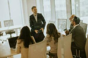 Young businessman presenting results to his coleagues in the office photo