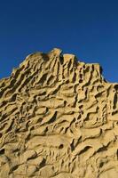 Closeup of Vlychada beach volcanic ash sand rock formation on Santorini island in Greece photo