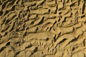 Closeup of Vlychada beach volcanic ash sand rock formation on Santorini island in Greece photo