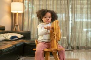 contento africano americano niña jugando en vivo habitación a hogar foto