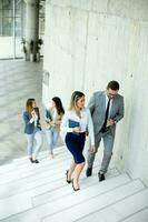 Young startup team have a discussion while climbing on  stairs in the office corridor photo