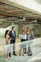 Young startup team working in the office corridor photo