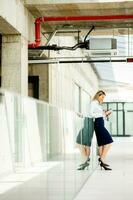 Young woman working on digital tablet in the office hallway photo