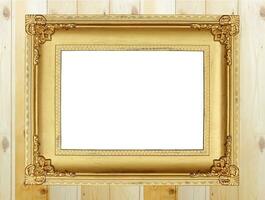 Antique gold frame on wooden wall photo