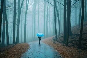 Woman under blue umbrella walks in the park on a foggy day. Generative AI photo