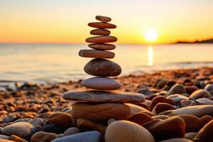Balanced rock pyramid on sea pebbles beach, sunny day. photo