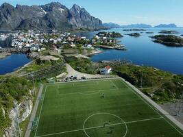 Aerial view of fishing village and football field on Lofoten Islands in Norway photo