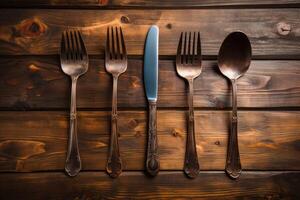 Antique spoon and fork, knife on a wooden table. photo