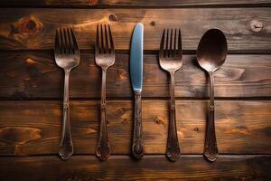 Antique spoon and fork, knife on a wooden table. Generative AI photo