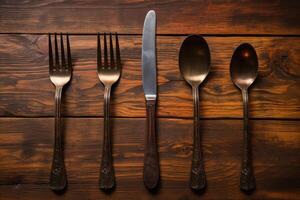 Antique spoon and fork, knife on a wooden table. Generative AI photo