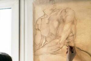 artist copies graphic drawing on window photo