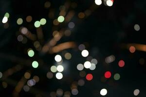 On a black background bokeh from explosions of colorful fireworks. photo