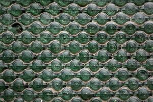 Vintage mosaic from old bottles. Ecological use of old bottles for mosaic on the wall. Texture of glass jars. photo