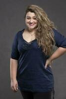 Beautiful fat woman on a gray background. photo