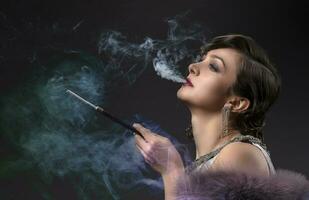 Retro woman portrait. Beautiful woman in the style of 20s or 30s with a mouthpiece in colored smoke. photo