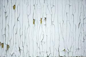 Texture of an old wall with peeling white paint. photo