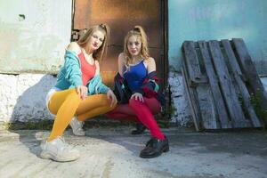 Funny girls in the style of the 90s in bright clothes. photo
