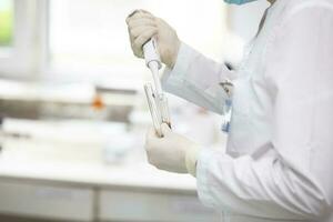 Medical laboratory. The doctor's hands are holding glass test tubes. photo