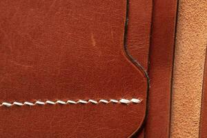 Part of a brown leather wallet or purse close-up. photo