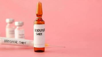 a syringe with a label that says, Booster shot video
