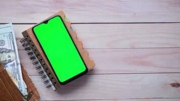 money and smartphone on a wooden table video