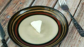 a piece of cheese on a plate with a fork and knife video