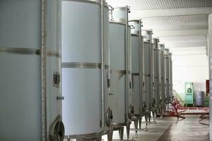 Industrial metal tanks for wine at a plant for the production of alcoholic beverages. photo