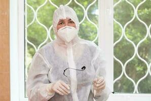 A doctor in a protective medical suit during the coronavirus epidemic. photo