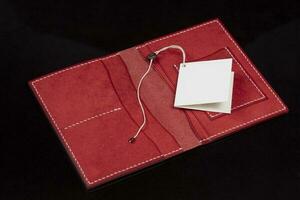 Open leather red purse with pockets on a dark background. photo