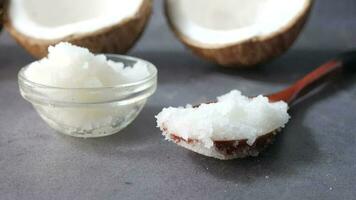 A spoon of coconut oil on black background video