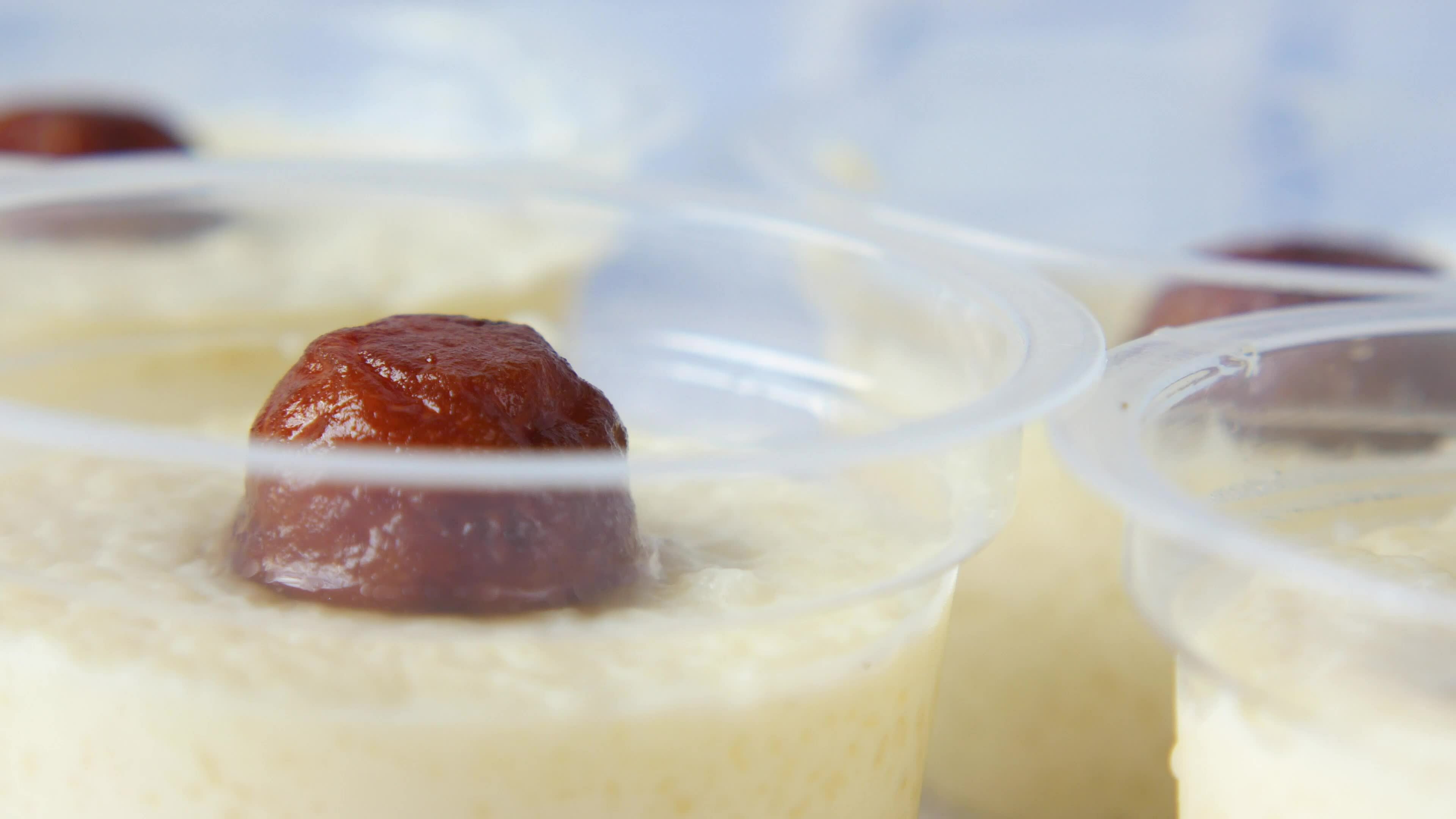 four cups of pudding with dates in them 26456454 Stock Video at Vecteezy