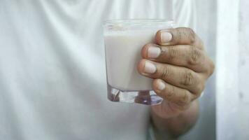 a man holding a glass of milk video