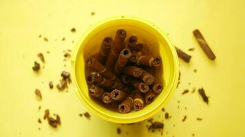 a yellow bowl filled with chocolate wafer roll video