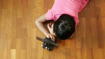 Overhead view of child using tablet on floor video