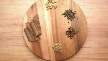 a wooden cutting board with spices and herbs video