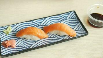 two pieces of sushi on a blue and white plate video