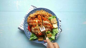 slice of chicken meat, rice and fresh vegetable salad on table video