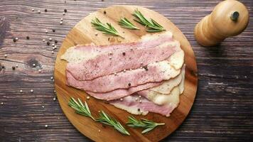 Raw fed bacon strips on chopping board video