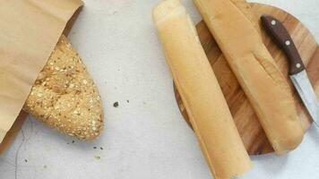 top view of whole grain bread taking out from a paper shopping bag video