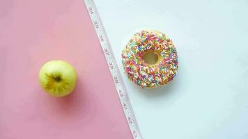 comparing donuts with apple on table video